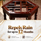 A dark brown wooden hexagonal table with a slatted top and metal rivet details, shown above a promotional banner that reads 'Repels Rain for up to 12 Months' with stain and spill protection claims.